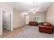 Inviting living area with tile and carpet, showcasing a cozy leather sofa and ample natural light at 163 W Dragon Tree Ave, Queen Creek, AZ 85140