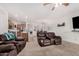 Relaxing living room, featuring reclining furniture and views into the kitchen at 163 W Dragon Tree Ave, Queen Creek, AZ 85140