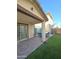 Covered patio with outdoor dining set and artificial turf at 16425 W Latham St, Goodyear, AZ 85338