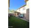 Artificial turf backyard with covered patio and dining area at 16425 W Latham St, Goodyear, AZ 85338