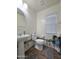 Clean bathroom featuring pedestal sink, toilet, and window at 16425 W Latham St, Goodyear, AZ 85338