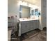 Modern bathroom with double vanity and large mirror at 16425 W Latham St, Goodyear, AZ 85338