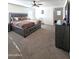 Large bedroom with king-size bed, dresser, and additional space at 16425 W Latham St, Goodyear, AZ 85338