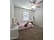 Bedroom with queen bed, vanity, and ceiling fan at 16425 W Latham St, Goodyear, AZ 85338