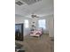 Bedroom with ceiling fan, windows, and a TV mount at 16425 W Latham St, Goodyear, AZ 85338