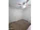 Bright bedroom with ceiling fan and double doors at 16425 W Latham St, Goodyear, AZ 85338