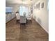 Modern dining room with glass top table and six light-beige chairs at 16425 W Latham St, Goodyear, AZ 85338