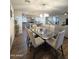 Open concept dining area with a glass-top table and kitchen view at 16425 W Latham St, Goodyear, AZ 85338