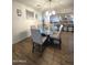 Modern dining room with glass top table and six light-beige chairs at 16425 W Latham St, Goodyear, AZ 85338