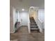 Bright entryway with tile flooring, staircase, and a stylish console table at 16425 W Latham St, Goodyear, AZ 85338