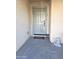 Light teal front door with welcome mat at 16425 W Latham St, Goodyear, AZ 85338