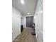 Bright hallway with neutral walls and wood flooring at 16425 W Latham St, Goodyear, AZ 85338