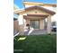 Covered patio with artificial turf and grill at 16425 W Latham St, Goodyear, AZ 85338