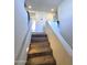 Carpeted staircase with white railings and lighting at 16425 W Latham St, Goodyear, AZ 85338