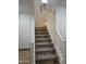 Carpeted staircase with white railings at 16425 W Latham St, Goodyear, AZ 85338