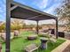 Relaxing backyard oasis with pergola, fire pit, and artificial turf at 16833 S 177Th Ln, Goodyear, AZ 85338