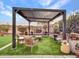 Artificial turf backyard with modern pergola and fire pit at 16833 S 177Th Ln, Goodyear, AZ 85338