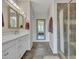 Bathroom with double vanity, large mirror, and walk-in shower at 16833 S 177Th Ln, Goodyear, AZ 85338