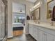 Double vanity bathroom with a view of the bedroom from the mirror at 16833 S 177Th Ln, Goodyear, AZ 85338