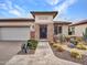 Front view of a tan home with a landscaped yard at 16833 S 177Th Ln, Goodyear, AZ 85338