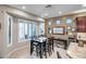 Bright breakfast nook features a table with four chairs and large windows with plantation shutters at 17164 S 174Th Dr, Goodyear, AZ 85338