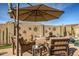 Comfortable patio furniture under an umbrella, ideal for outdoor lounging at 17164 S 174Th Dr, Goodyear, AZ 85338