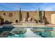 Inviting backyard pool with a stone fountain and decorative pots at 17164 S 174Th Dr, Goodyear, AZ 85338