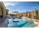 Inviting backyard oasis with a sparkling pool, patio furniture, and fire pit at 17164 S 174Th Dr, Goodyear, AZ 85338