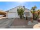 Single story home with white garage door and desert landscaping at 1823 E Riviera Dr, Chandler, AZ 85249