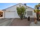 Single story home with white garage door and desert landscaping at 1823 E Riviera Dr, Chandler, AZ 85249