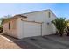 Single story home with white garage door and desert landscaping at 1823 E Riviera Dr, Chandler, AZ 85249