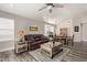 Bright living room featuring hardwood floors, a leather couch, and a ceiling fan at 1823 E Riviera Dr, Chandler, AZ 85249