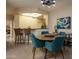 Bright dining area with a round table and teal chairs at 18619 N 136Th Dr, Sun City West, AZ 85375