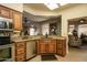 Kitchen with wood cabinets, granite counters, and breakfast bar at 18619 N 136Th Dr, Sun City West, AZ 85375