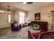 Living room with comfy maroon couches and purple accent chair at 18619 N 136Th Dr, Sun City West, AZ 85375