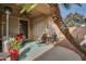 Enjoy this inviting patio with seating, a ceiling fan and potted plants at 18619 N 136Th Dr, Sun City West, AZ 85375