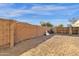 Gravel backyard with block wall and wooden gates at 1902 E Bruce Ave, Gilbert, AZ 85234