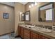 Double vanity bathroom with neutral tile and updated fixtures at 1902 E Bruce Ave, Gilbert, AZ 85234