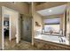 Bathroom with soaking tub, shower, and access to other rooms at 1902 E Bruce Ave, Gilbert, AZ 85234