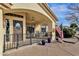 Covered porch with a decorative door and American flag at 1902 E Bruce Ave, Gilbert, AZ 85234