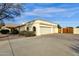 Two-car garage with wood doors and a long driveway at 1902 E Bruce Ave, Gilbert, AZ 85234