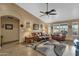 Living room with leather couches and a ceiling fan at 1902 E Bruce Ave, Gilbert, AZ 85234