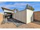 Property features covered work area and metal storage sheds at 1902 E Bruce Ave, Gilbert, AZ 85234