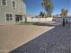 Spacious backyard with gravel, artificial turf, and fire pit at 19203 N Marbella Ave, Maricopa, AZ 85138