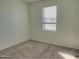 Simple bedroom with carpeted floors and window at 19203 N Marbella Ave, Maricopa, AZ 85138