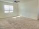 Spacious bedroom with carpeted floor and ceiling fan at 19203 N Marbella Ave, Maricopa, AZ 85138