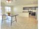 Open dining area with kitchen access and tile floors at 19203 N Marbella Ave, Maricopa, AZ 85138