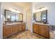 Double vanity bathroom with wood cabinets and tile flooring at 19334 W Pasadena Ave, Litchfield Park, AZ 85340