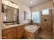 Elegant bathroom with soaking tub, shower, and wood vanity at 19334 W Pasadena Ave, Litchfield Park, AZ 85340