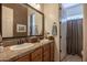 Double vanity bathroom with wood cabinets and tile countertops at 19334 W Pasadena Ave, Litchfield Park, AZ 85340